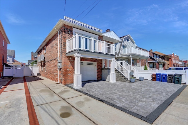 161 Bch 129th St, Rockaway Park, NY 11694 - view of front of home featuring a gate, brick siding, fence, and a balcony
