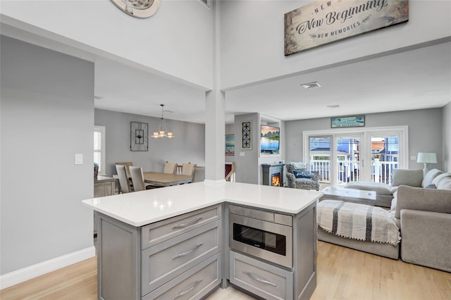 161 Bch 129th St, Rockaway Park, NY 11694 - kitchen with gray cabinets, open floor plan, light wood-style flooring, and light countertops