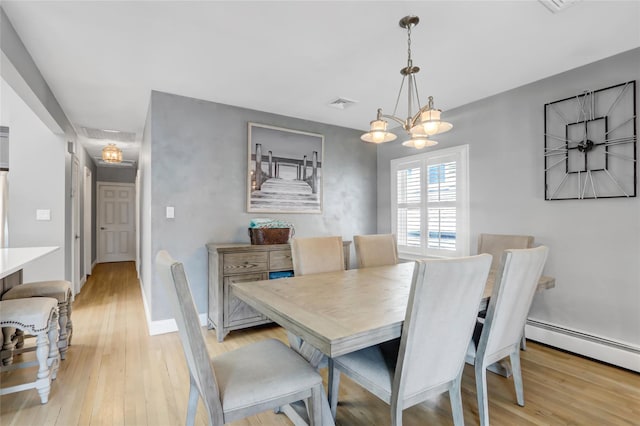 161 Bch 129th St, Rockaway Park, NY 11694 - dining space with light wood-style flooring, a chandelier, and baseboards