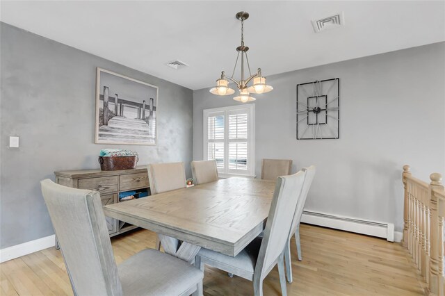 161 Bch 129th St, Rockaway Park, NY 11694 - dining room with baseboard heating, light wood finished floors, a chandelier, and baseboards