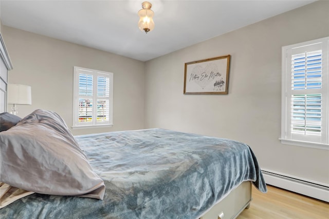 161 Bch 129th St, Rockaway Park, NY 11694 - bedroom with a baseboard radiator and light wood-style flooring