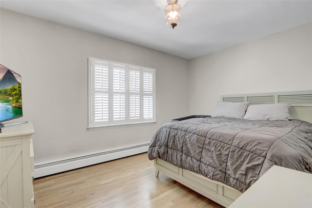 161 Bch 129th St, Rockaway Park, NY 11694 - bedroom with baseboard heating and wood finished floors