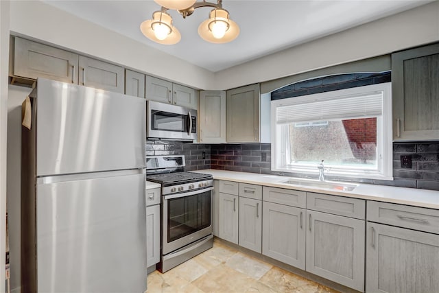 161 Bch 129th St, Rockaway Park, NY 11694 - kitchen with appliances with stainless steel finishes, gray cabinetry, a sink, and light countertops