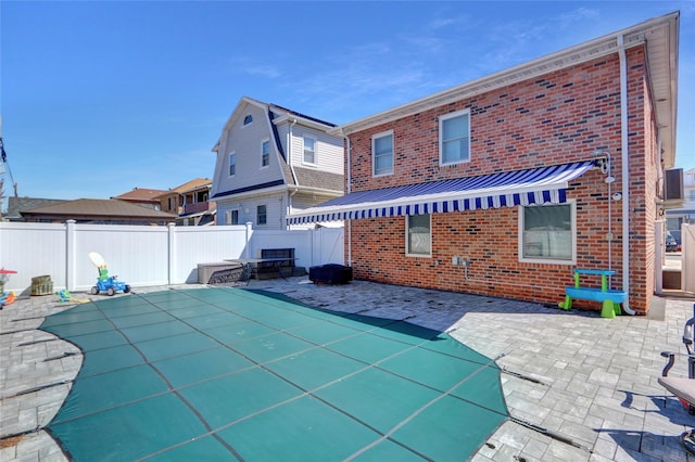 161 Bch 129th St, Rockaway Park, NY 11694 - back of property featuring brick siding, a fenced backyard, a patio, and metal roof