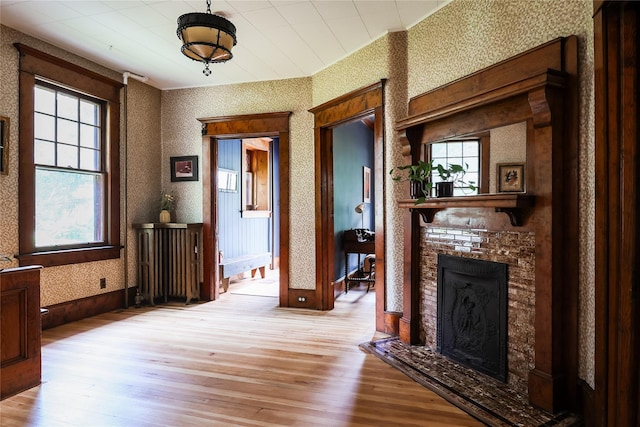 12 Highview Ave, Callicoon, NY 12723 - living area featuring wood finished floors, a fireplace, and wallpapered walls