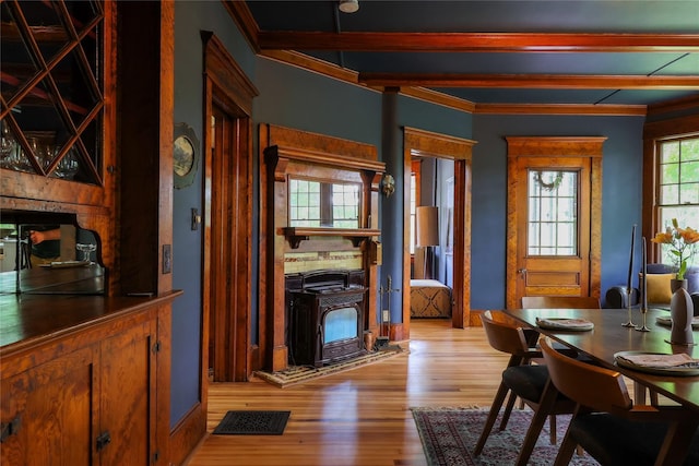 12 Highview Ave, Callicoon, NY 12723 - dining room with light wood-style flooring, crown molding, a wood stove, and beam ceiling