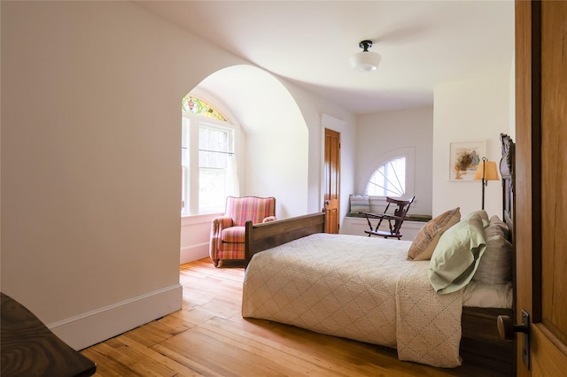 12 Highview Ave, Callicoon, NY 12723 - bedroom with multiple windows, light wood-style floors, and arched walkways
