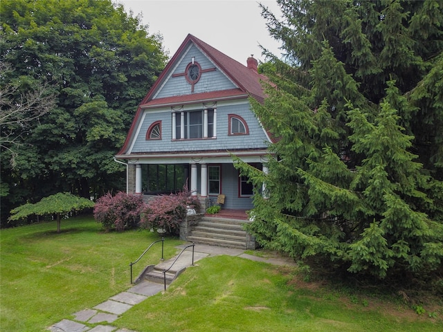 12 Highview Ave, Callicoon, NY 12723 - victorian home featuring covered porch, a chimney, and a front lawn