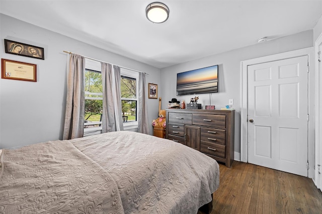 bedroom featuring dark wood-style floors