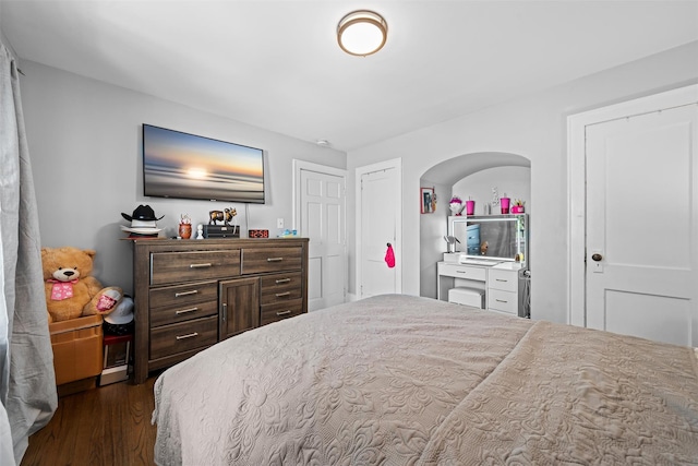 bedroom with dark wood-style flooring
