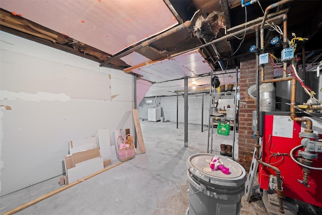 unfinished basement with a heating unit and washer / clothes dryer