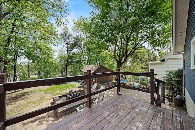 wooden terrace featuring an outbuilding