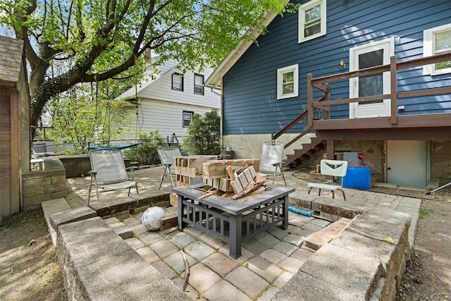 view of patio / terrace featuring stairs and fence