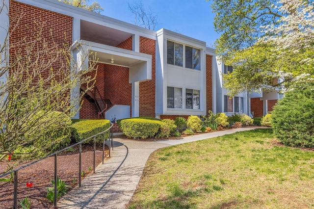 523 Colony Dr, Hartsdale, NY 10530 - view of front facade featuring a front yard and brick siding