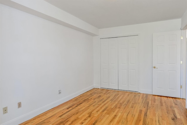 523 Colony Dr, Hartsdale, NY 10530 - unfurnished bedroom with baseboards, a closet, and light wood-type flooring