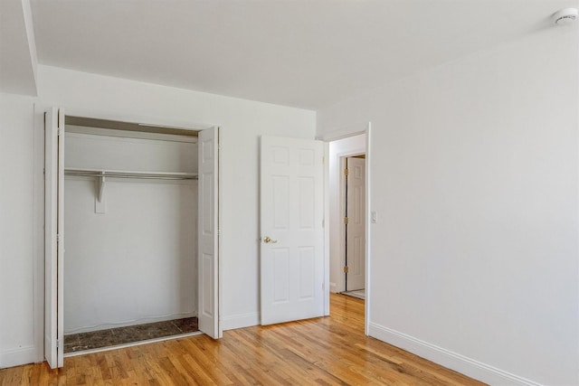 523 Colony Dr, Hartsdale, NY 10530 - unfurnished bedroom with baseboards, a closet, and light wood-style flooring
