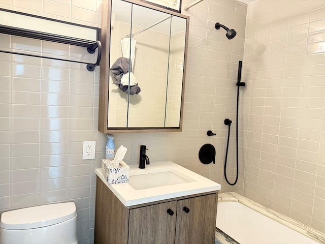 bathroom featuring vanity, shower / bath combination, toilet, and tile walls