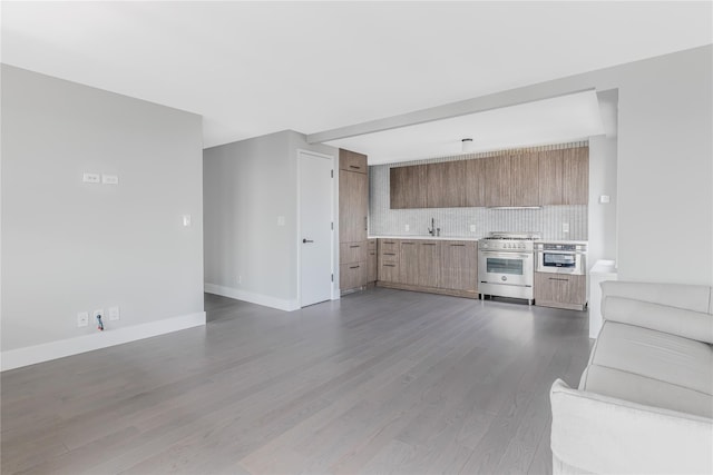 175 W 95th St Unit 27G, New York Manhattan, NY 10025 - kitchen featuring stainless steel appliances, modern cabinets, open floor plan, decorative backsplash, and light countertops
