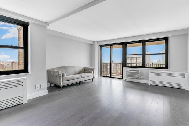 175 W 95th St Unit 27G, New York Manhattan, NY 10025 - living area featuring baseboards, radiator, a wall unit AC, and wood finished floors