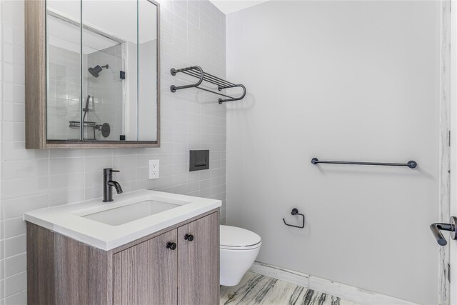 175 W 95th St Unit 27G, New York Manhattan, NY 10025 - bathroom featuring tile walls, toilet, a shower with door, and vanity