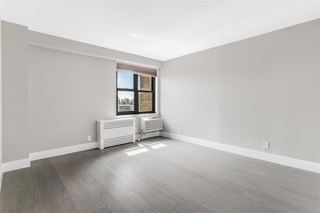 175 W 95th St Unit 27G, New York Manhattan, NY 10025 - empty room with radiator, wood finished floors, and baseboards