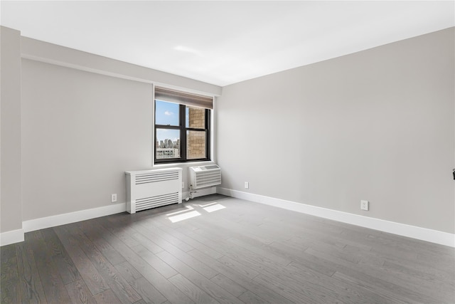 175 W 95th St Unit 27G, New York Manhattan, NY 10025 - spare room with radiator, baseboards, a wall unit AC, and wood finished floors