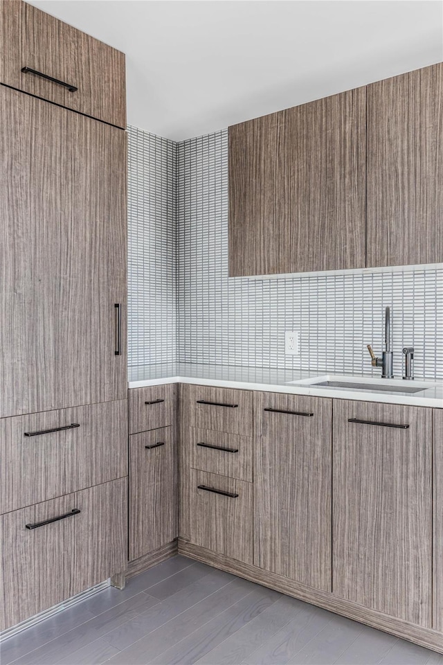 175 W 95th St Unit 27G, New York Manhattan, NY 10025 - bathroom featuring a sink, decorative backsplash, and wood finished floors