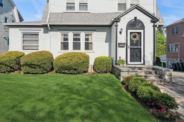 219 Third Ave, Pelham, NY 10803 - view of front of home with a front lawn, stucco siding, and a shingled roof