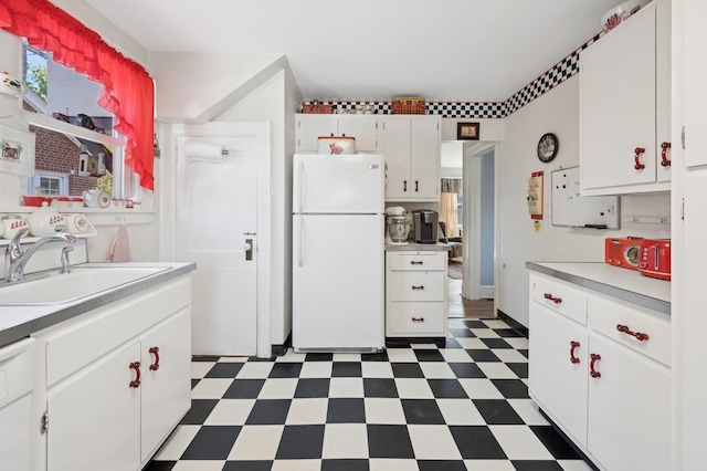 219 Third Ave, Pelham, NY 10803 - kitchen featuring freestanding refrigerator, dark floors, a sink, white cabinets, and light countertops