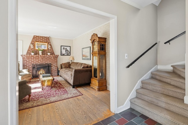 219 Third Ave, Pelham, NY 10803 - living room featuring ornamental molding, stairs, a fireplace, dark wood-type flooring, and baseboards