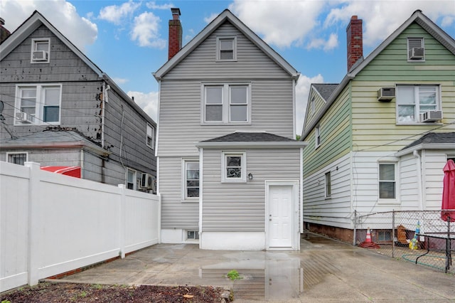 62-22 80th Rd, Glendale, NY 11385 - rear view of property featuring a patio, a fenced backyard, a chimney, and cooling unit