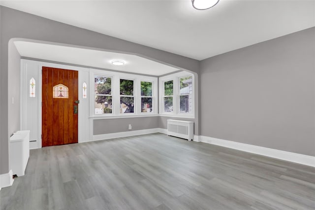 62-22 80th Rd, Glendale, NY 11385 - entryway with radiator heating unit, wood finished floors, and baseboards