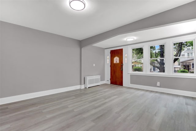 62-22 80th Rd, Glendale, NY 11385 - foyer featuring light wood finished floors, baseboards, and radiator heating unit