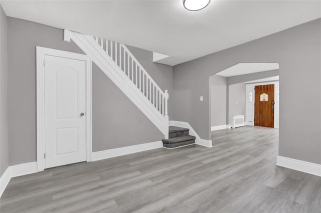 62-22 80th Rd, Glendale, NY 11385 - unfurnished living room with stairway, baseboards, and wood finished floors