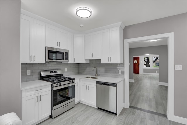 62-22 80th Rd, Glendale, NY 11385 - kitchen featuring stainless steel appliances, light countertops, baseboards, and a sink