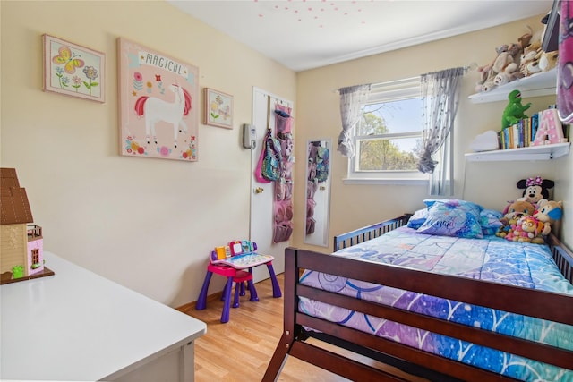 bedroom with baseboards and light wood-style flooring