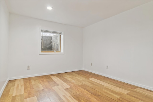 empty room with recessed lighting, baseboards, and light wood-type flooring