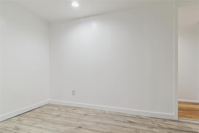 unfurnished room with recessed lighting, baseboards, and light wood-style floors