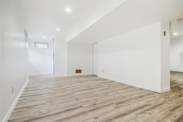 additional living space with light wood-type flooring, recessed lighting, and baseboards