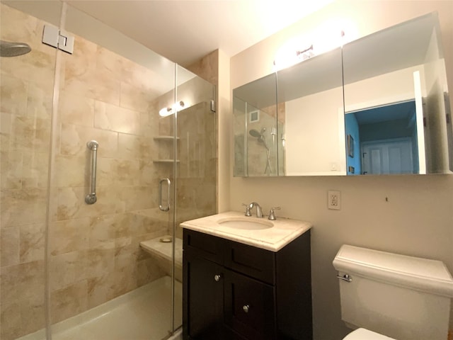 full bathroom featuring vanity, toilet, and a stall shower