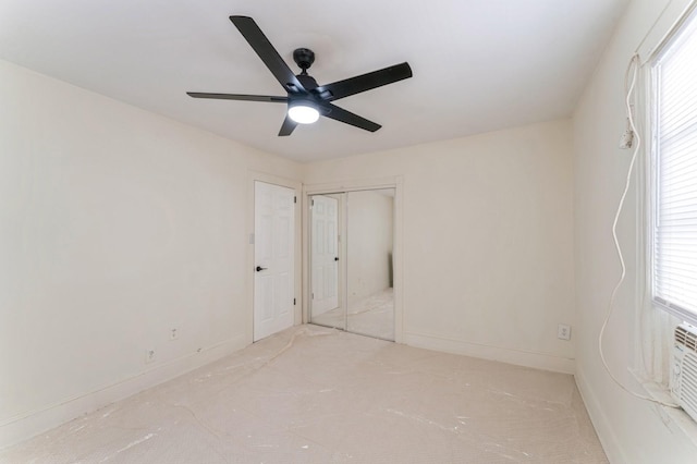 unfurnished bedroom with carpet flooring, ceiling fan, multiple windows, and a closet