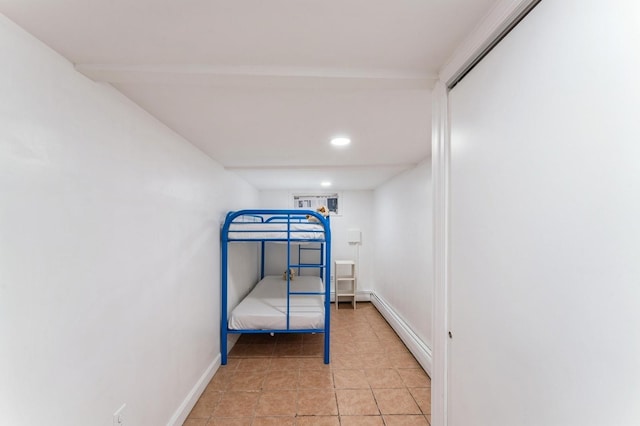 bedroom featuring recessed lighting, baseboards, a baseboard heating unit, and light tile patterned floors