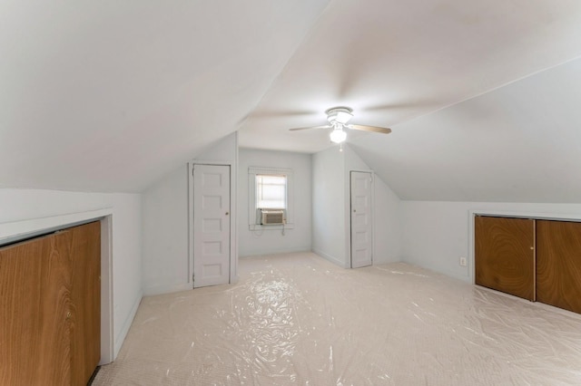 additional living space featuring ceiling fan, lofted ceiling, and light carpet