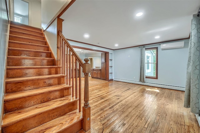 interior space featuring a wall mounted air conditioner, wood-type flooring, recessed lighting, baseboards, and a baseboard radiator