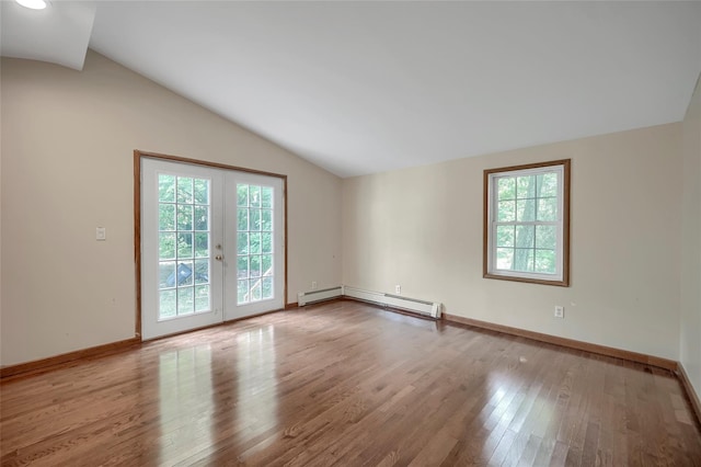 spare room with french doors, wood finished floors, baseboards, a baseboard radiator, and lofted ceiling