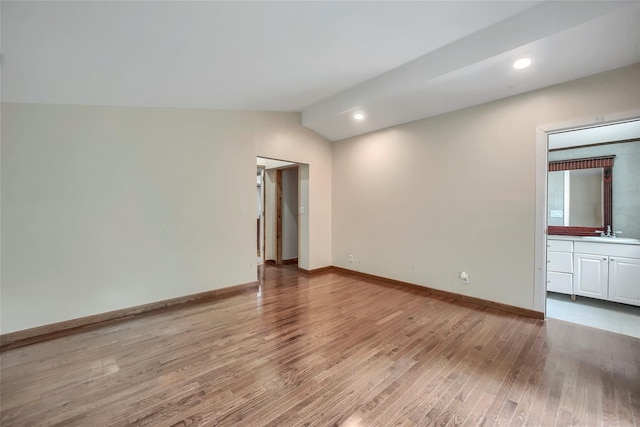 spare room with recessed lighting, baseboards, vaulted ceiling, and light wood-style floors