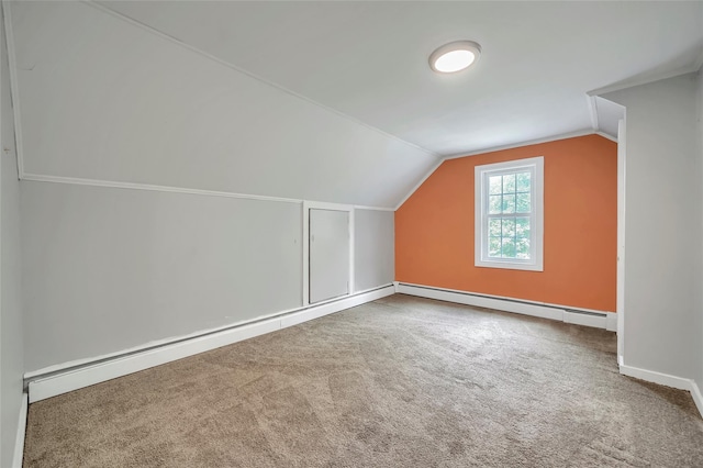 additional living space with vaulted ceiling, baseboards, a baseboard heating unit, and carpet flooring