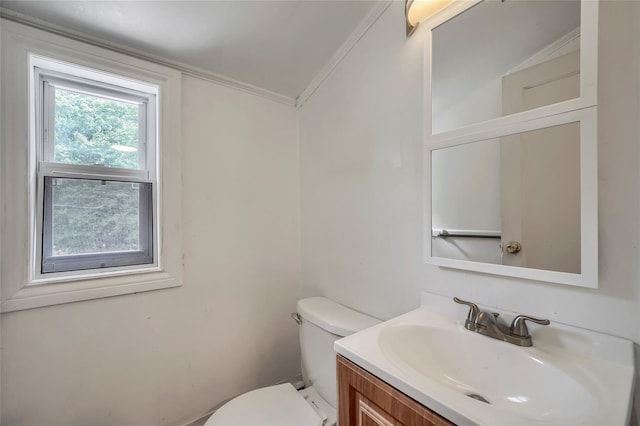 half bath with vanity, ornamental molding, and toilet