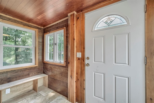 interior space featuring wooden ceiling and wood walls