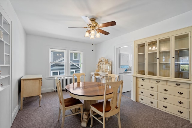 carpeted dining space with a ceiling fan, stacked washer / dryer, and radiator